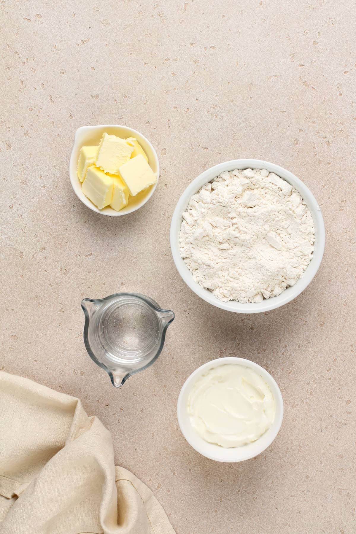 Ingredients for 7up biscuits on a beige countertop.