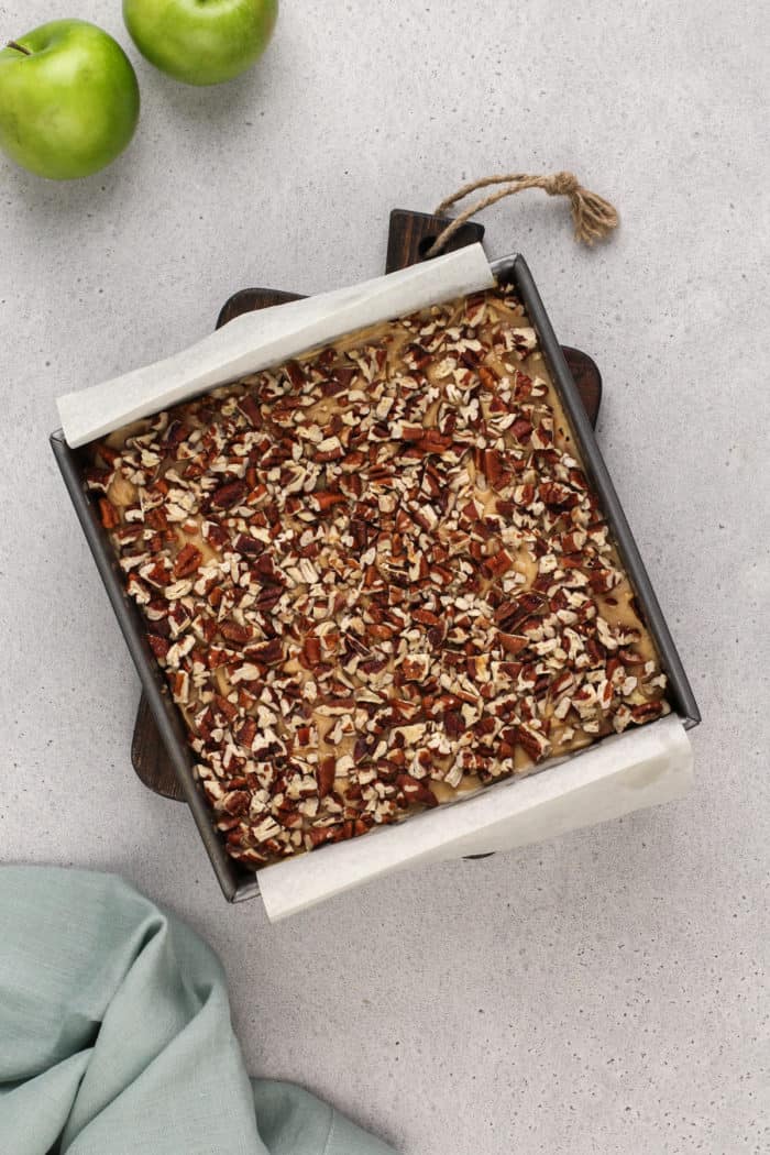 Assembled caramel apple blondies in a metal baking pan.