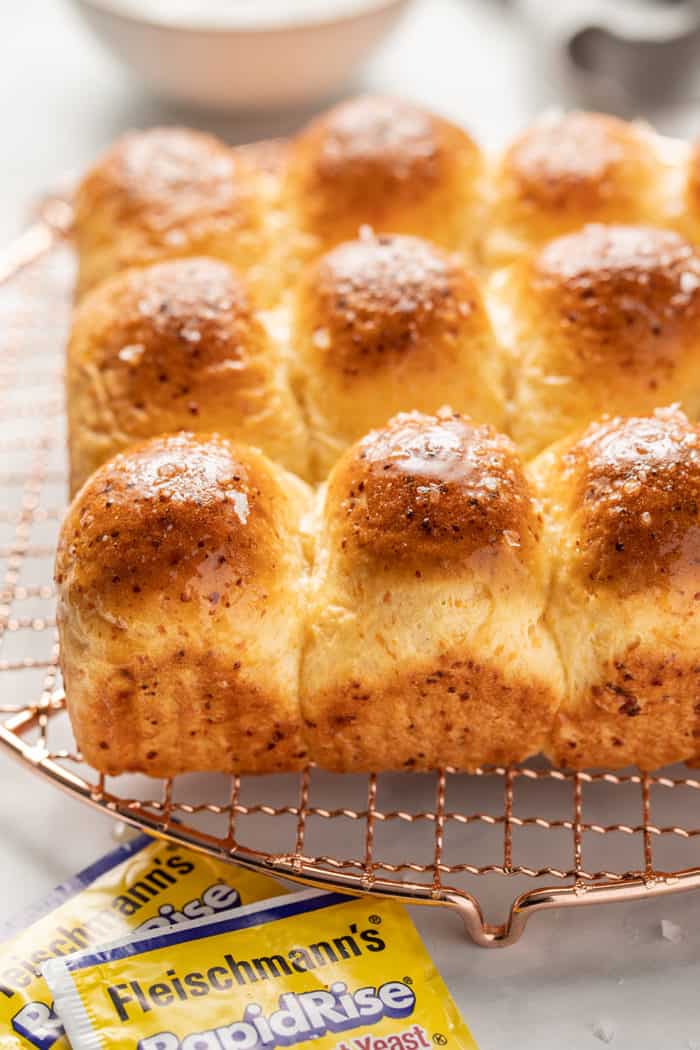 Baked cheddar dinner rolls removed from the pan and set on a cooling rack