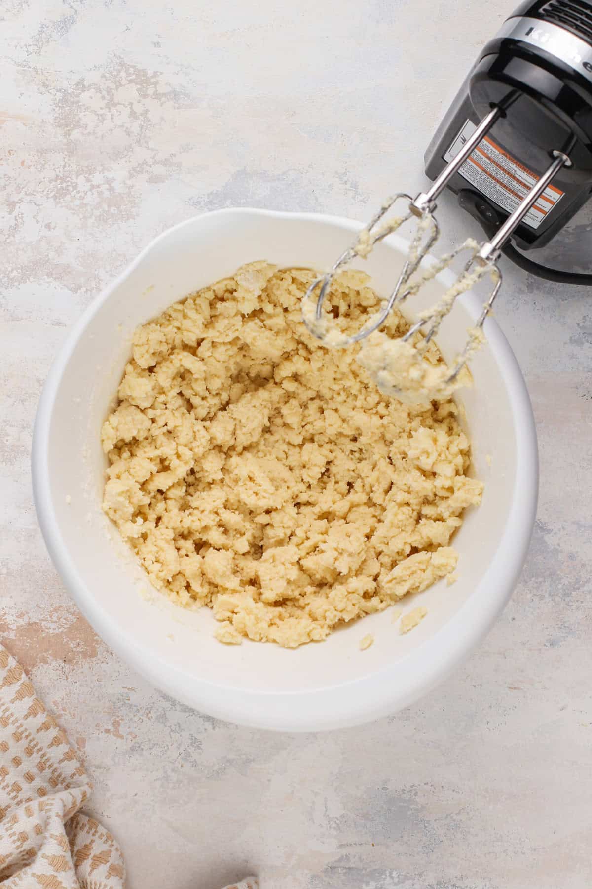 Cookie dough base for coconut sugar cookies in a white bowl.