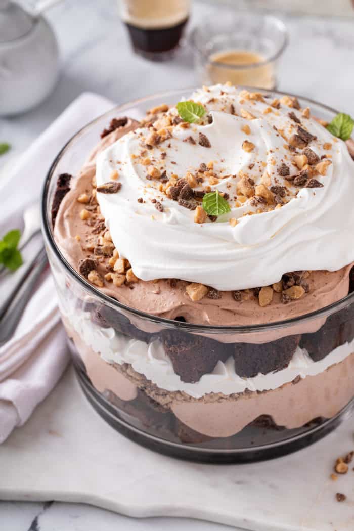 Close up of layers of brownie trifle in a glass trifle dish.