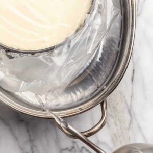 Adding boiling water to a roasting pan for a water bath