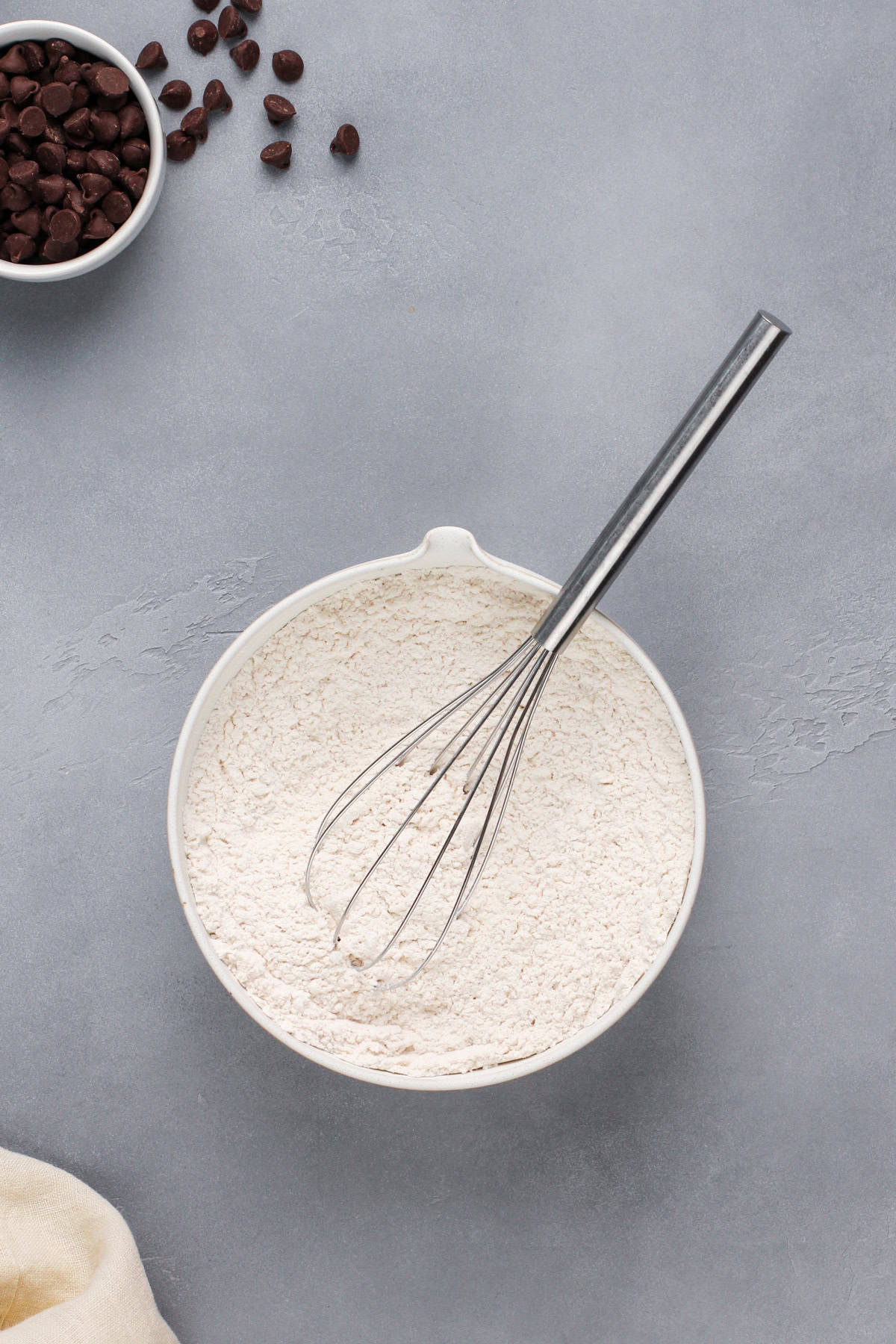 Dry ingredients for cookie bars in a white bowl.