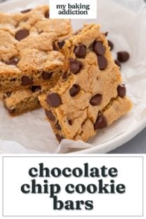 Chocolate chip cookie bar with a bite taken from it leaning against a stack of cookie bars on a white plate. Text overlay includes recipe name.