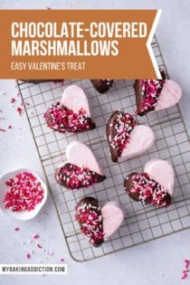 Overhead view of strawberry marshmallows cut into hearts and halfway dipped in chocolate. Text overlay includes recipe name.