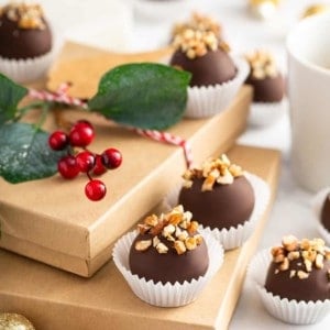 Turtle cookie balls arranged on holiday gift boxes