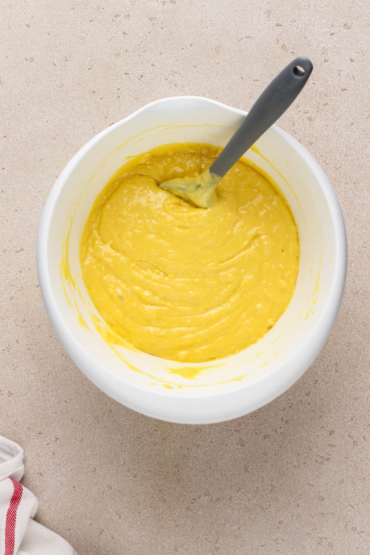 Batter for easy pineapple cake in a white bowl.