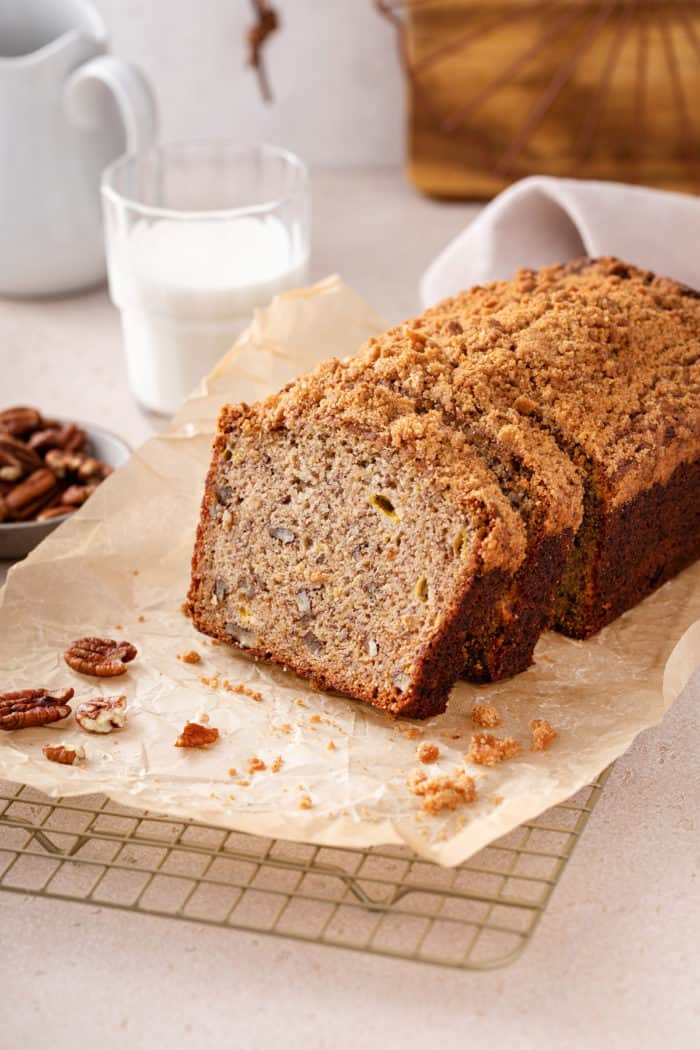 Several slices cut from a loaf of banana nut bread on a piece of parchment paper.