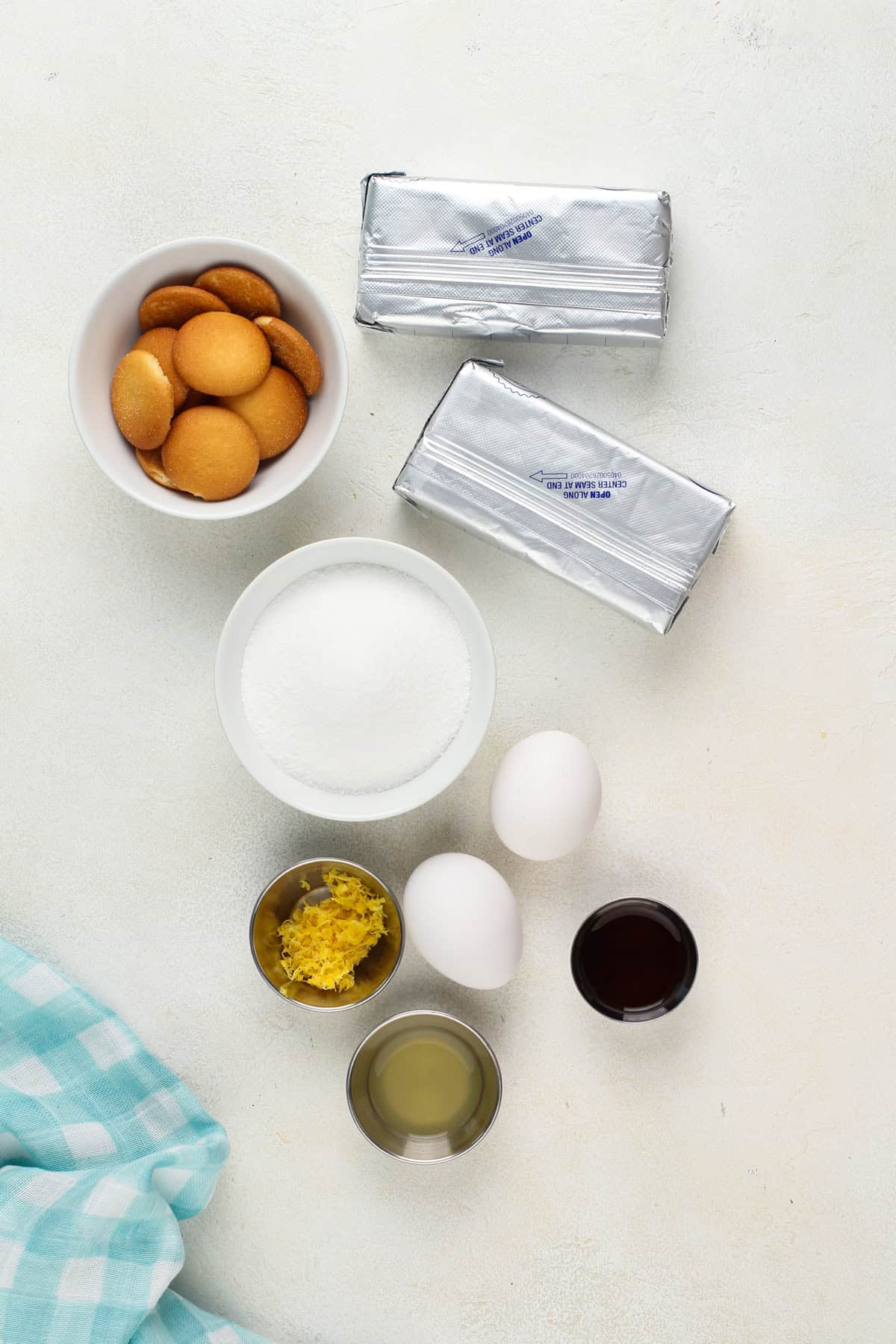 Mini lemon cheesecake ingredients arranged on a countertop.