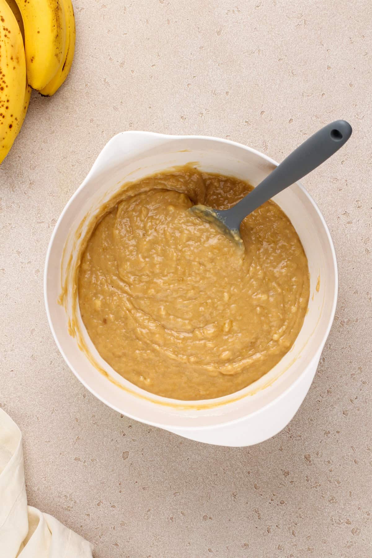 Peanut butter banana bread batter in a white bowl.