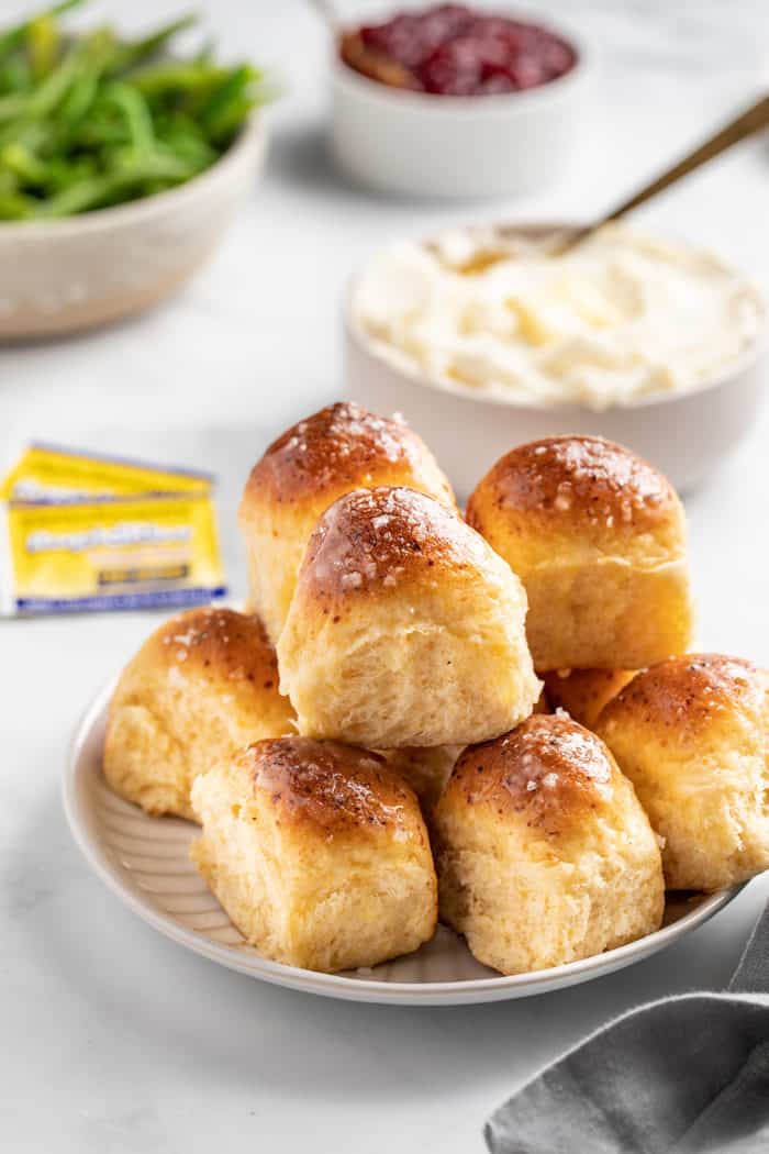 Dinner table featuring a plate full of cheddar dinner rolls