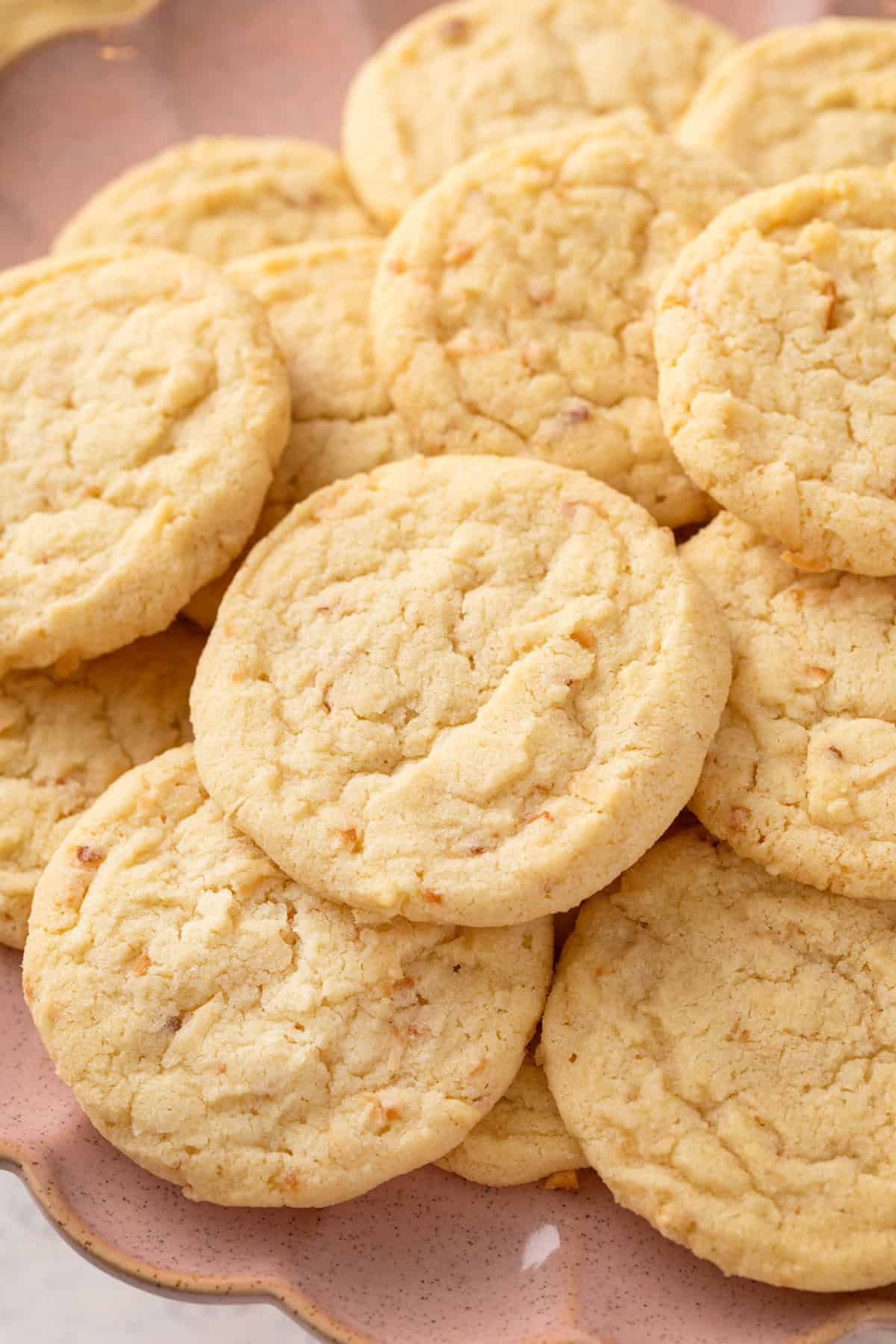 Coconut sugar cookies arranged on a pink platter.