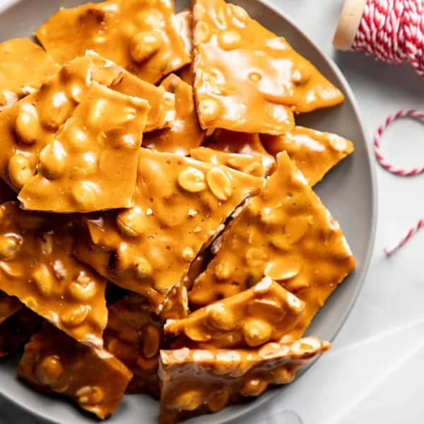 Plate stacked high with pieces of peanut brittle