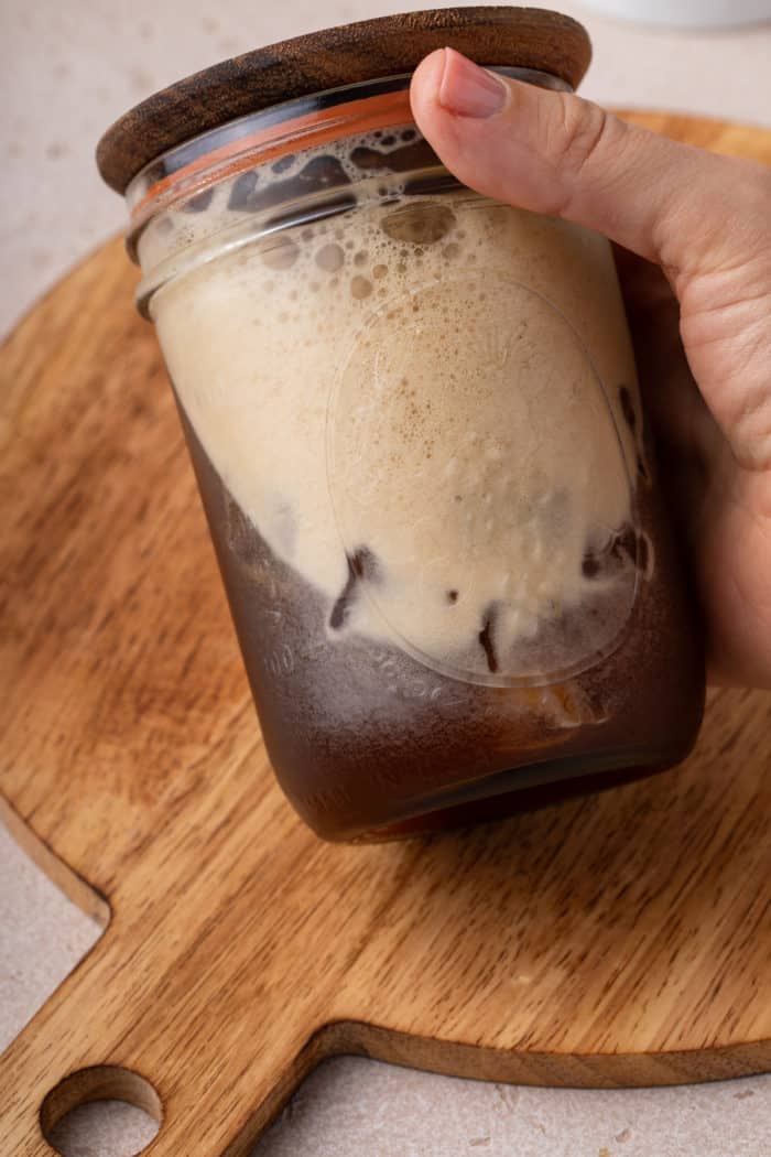 Mason jar filled with shaken espresso.