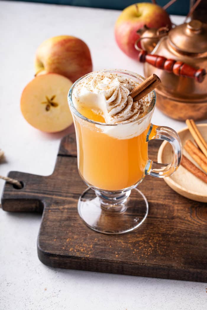 Mug of spiced apple cider with a sip taken out of it.