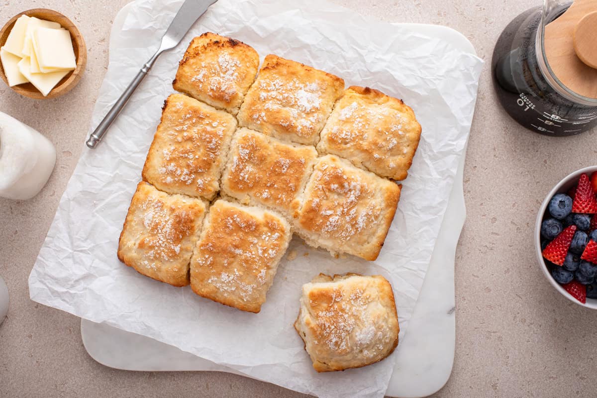 7up biscuits cut apart on a piece of parchment paper.