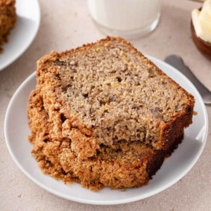 Sliced loaf of banana nut bread on a piece of parchment paper.