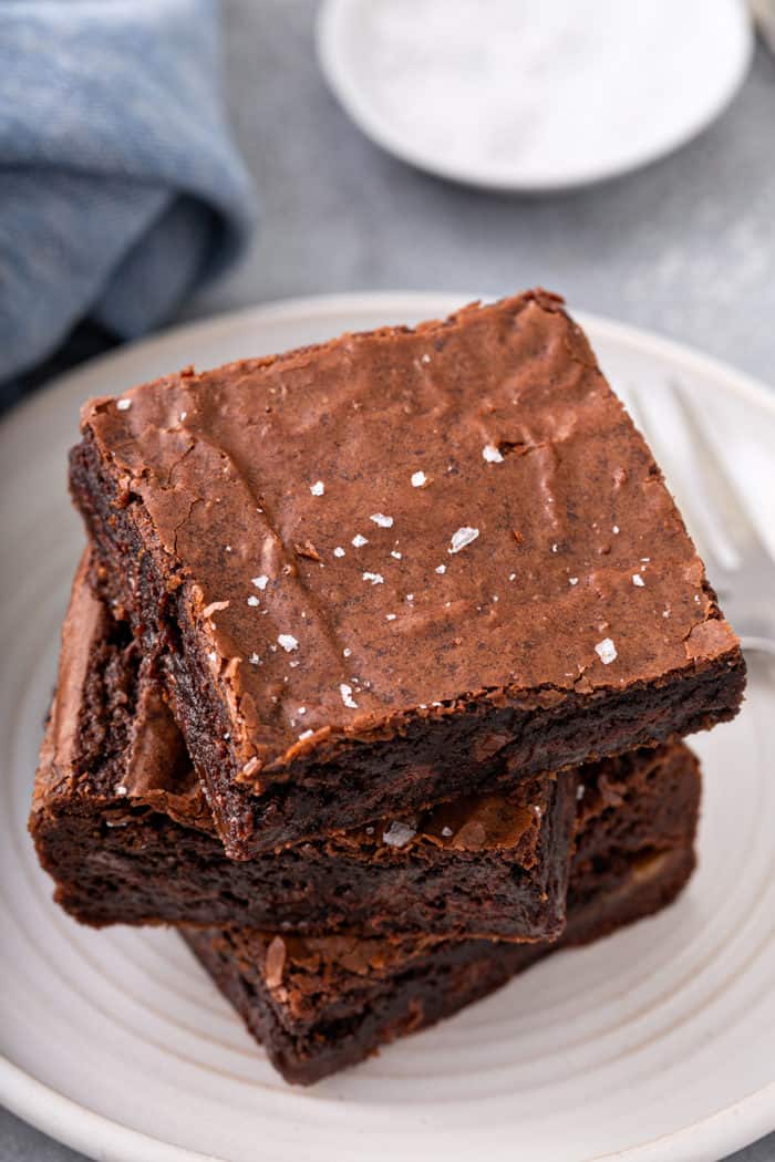 3 easy salted caramel brownies stacked on a white plate