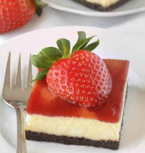 Strawberry white chocolate cheesecake bars have a chocolate cookie-like crust and strawberry jam topping. These are so good! Recipe contains a gluten-free option.