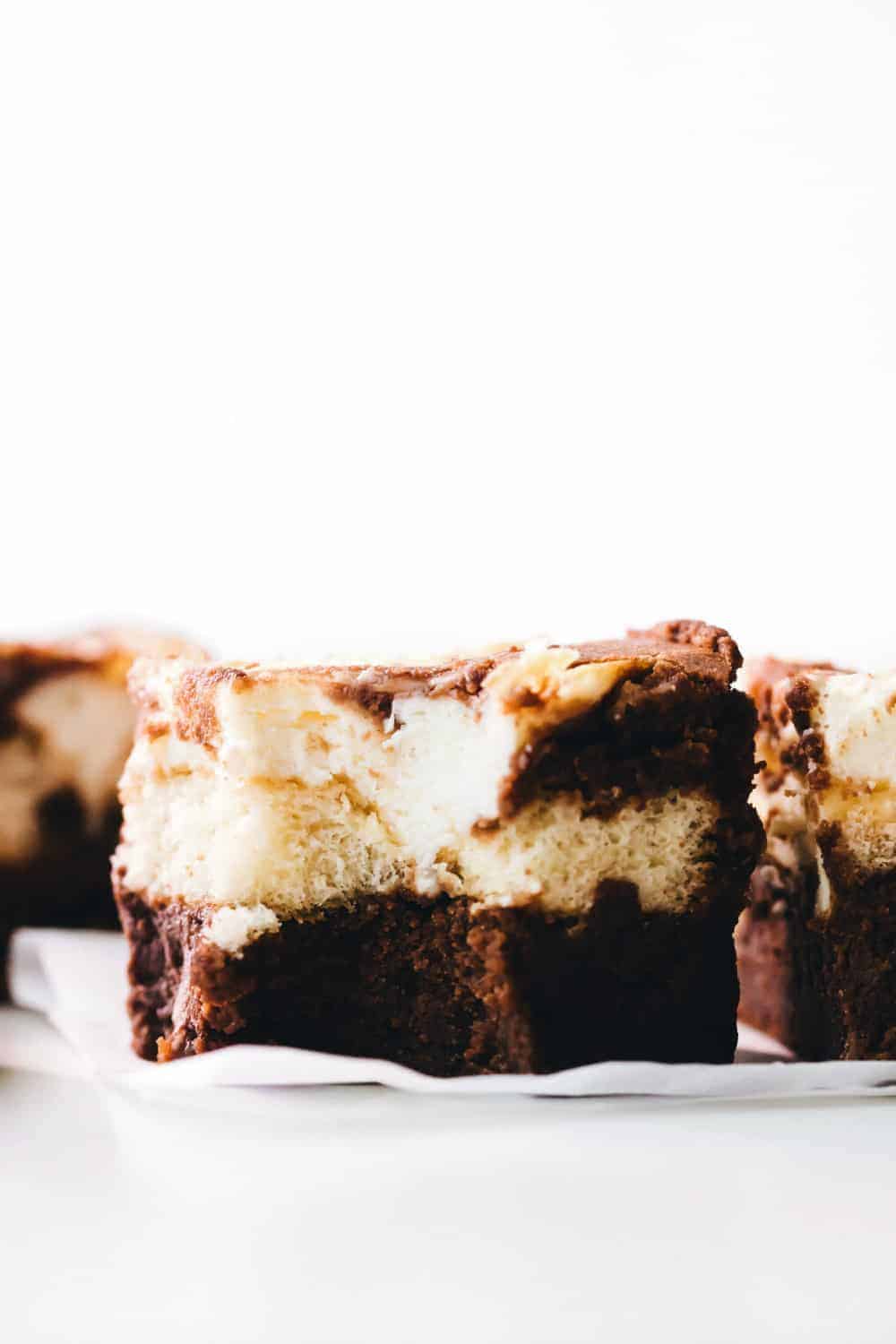 Side view of sliced tiramisu brownie with a bite taken out of it