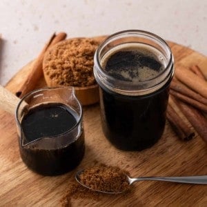 Two jars filled with brown sugar syrup.