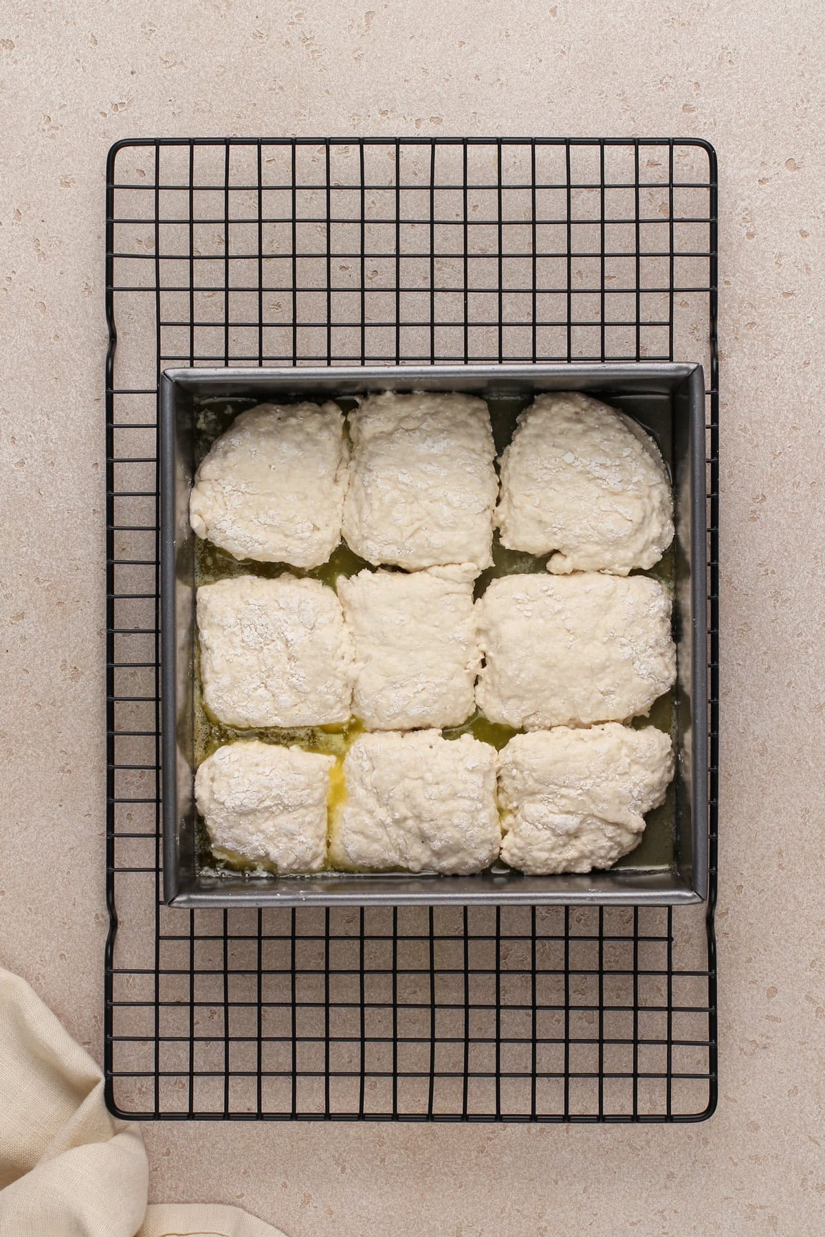 Unbaked 7up biscuits in a metal pan, ready to go in the oven.