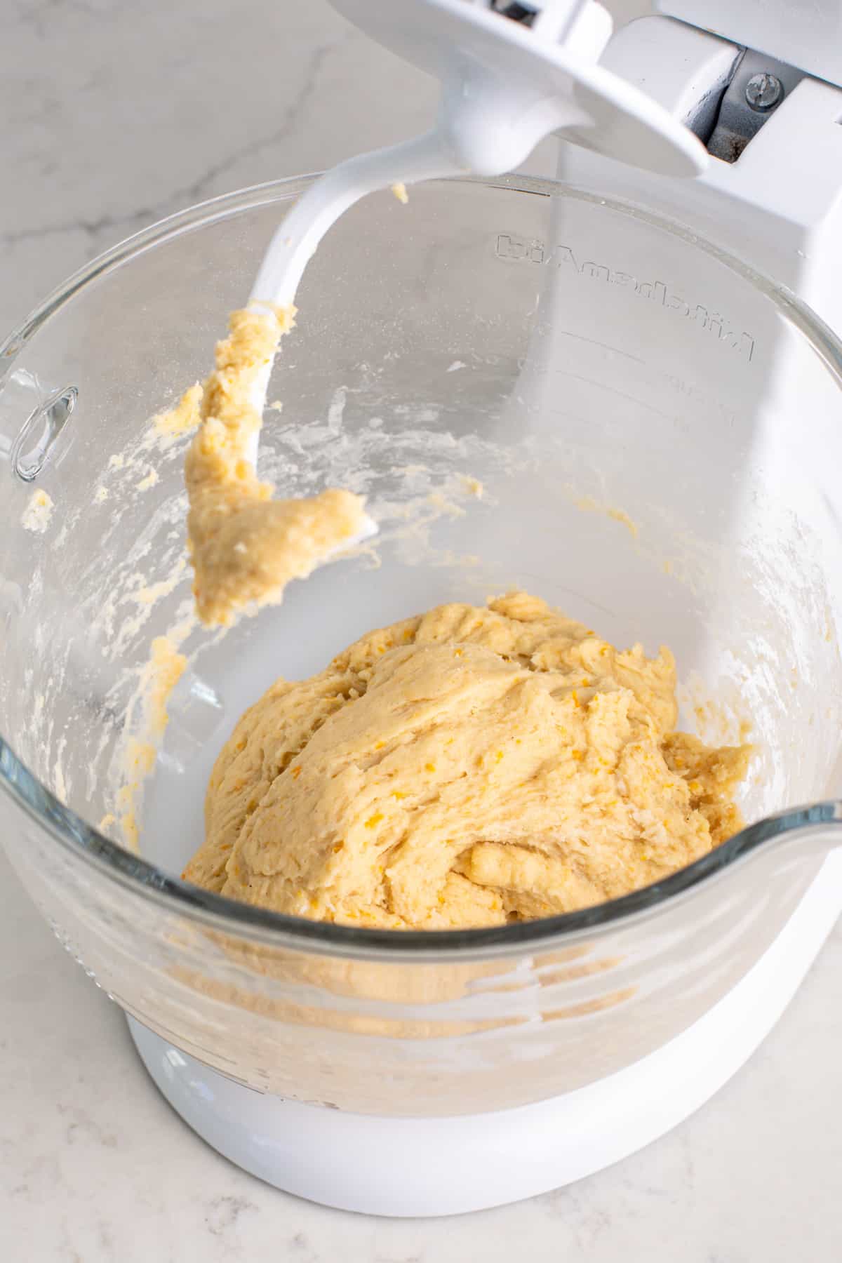 Mixed orange roll dough, ready to be kneaded.