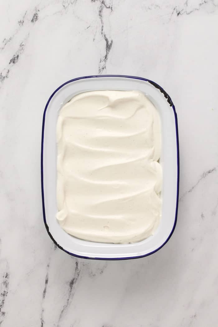 Vanilla no-churn ice cream spread into a freezer container.