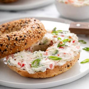 Veggie cream cheese spread on a bagel.